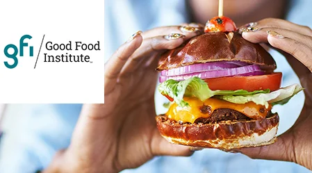 Hamburger végétal tenu par deux mains. Logo dans le coin supérieur gauche.