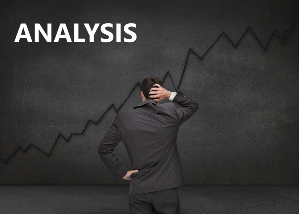 Analysis. Man in suit facing dark wall with rising curve