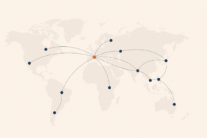 A stylised world map with a dozen soft nodes connected by thin arcs, one node in France gently highlighted in terracotta, the rest in navy.